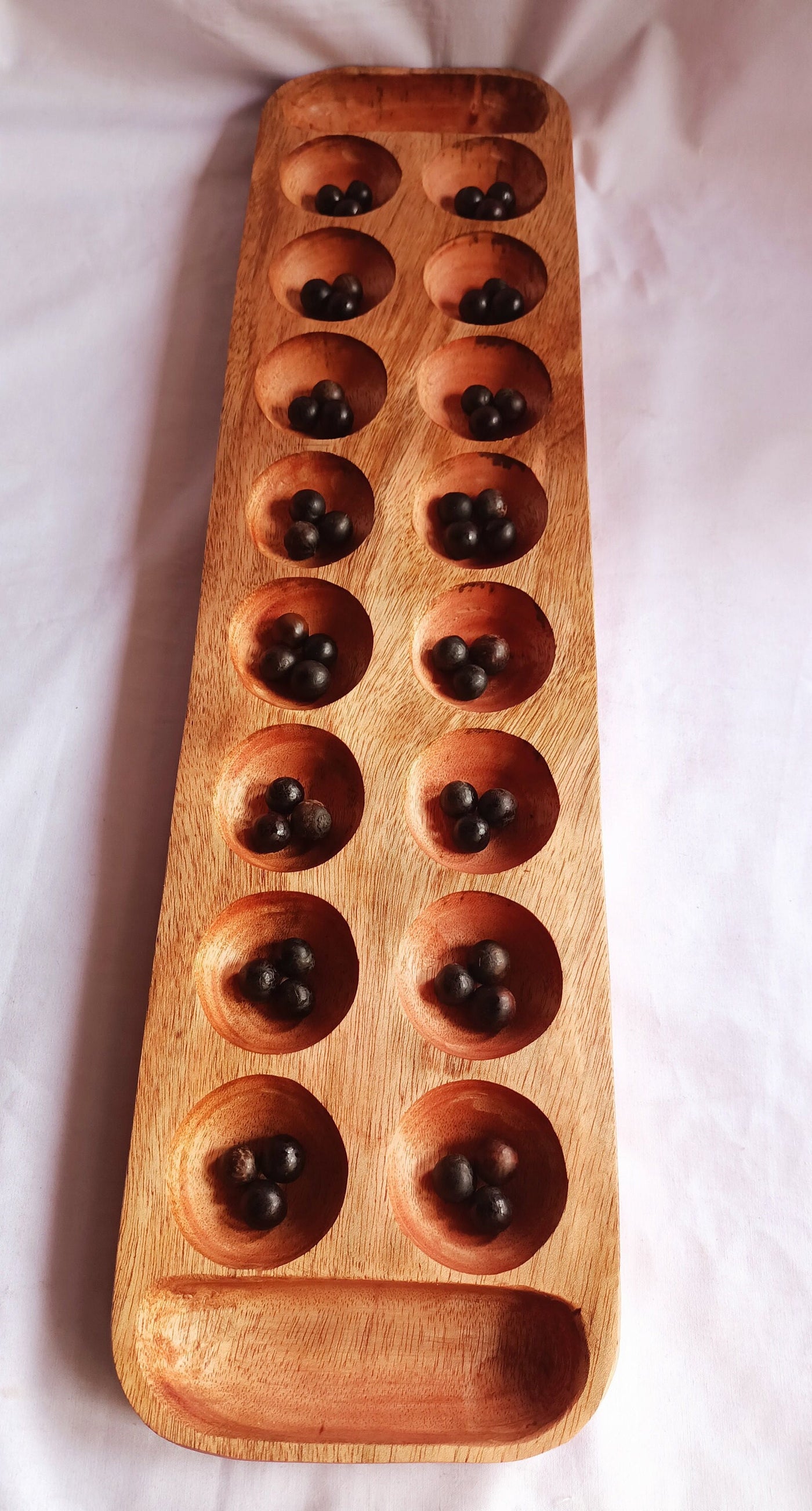 Wholesale . Large 24"×6" Mancalla Board Game With Natural Black Seeds.2 opponents Mankala 60 by 15 Cm with 16 Depressions and edge stores.