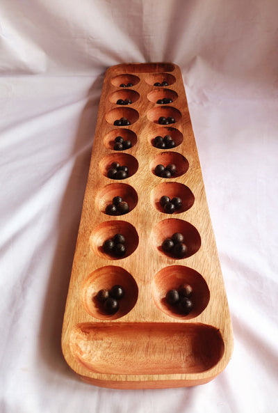 Wholesale . Large 24"×6" Mancalla Board Game With Natural Black Seeds.2 opponents Mankala 60 by 15 Cm with 16 Depressions and edge stores.