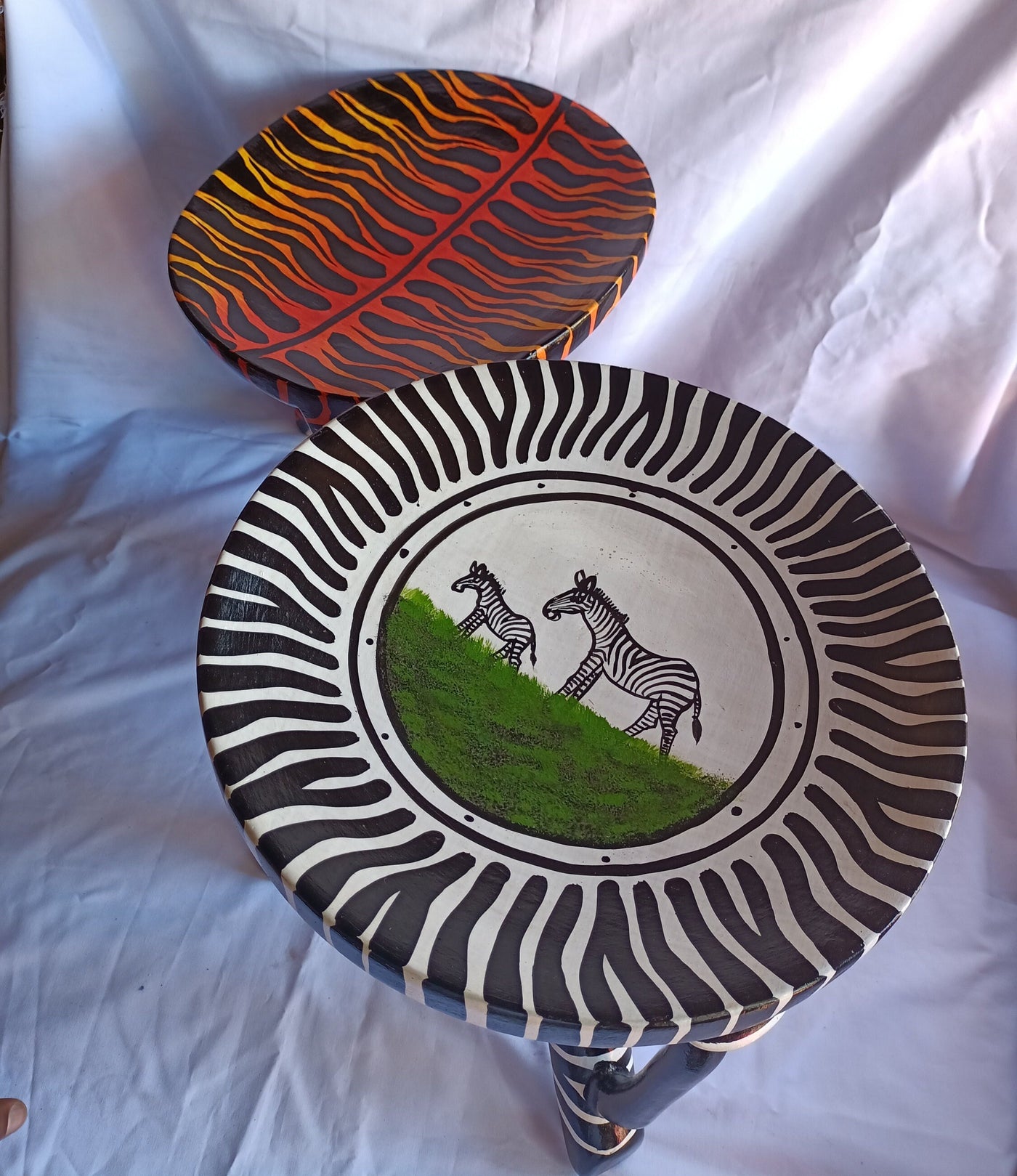 Two Gorgeous Hand carved Tiger and Zebra 3 legged Stools set of 2 with Handles. Modern maasai Wildlife Themed Stools. Bulk.The Senufo pair