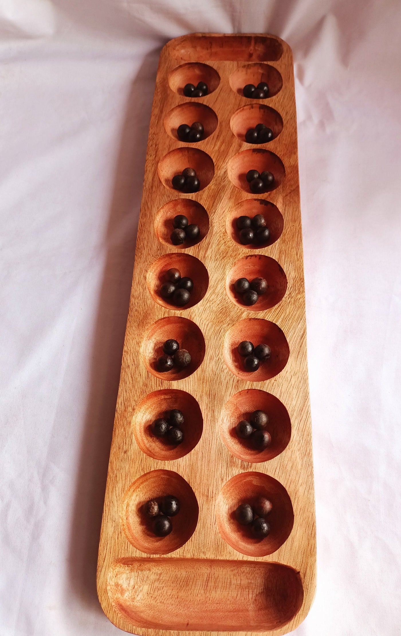 Wholesale . Large 24"×6" Mancalla Board Game With Natural Black Seeds.2 opponents Mankala 60 by 15 Cm with 16 Depressions and edge stores.