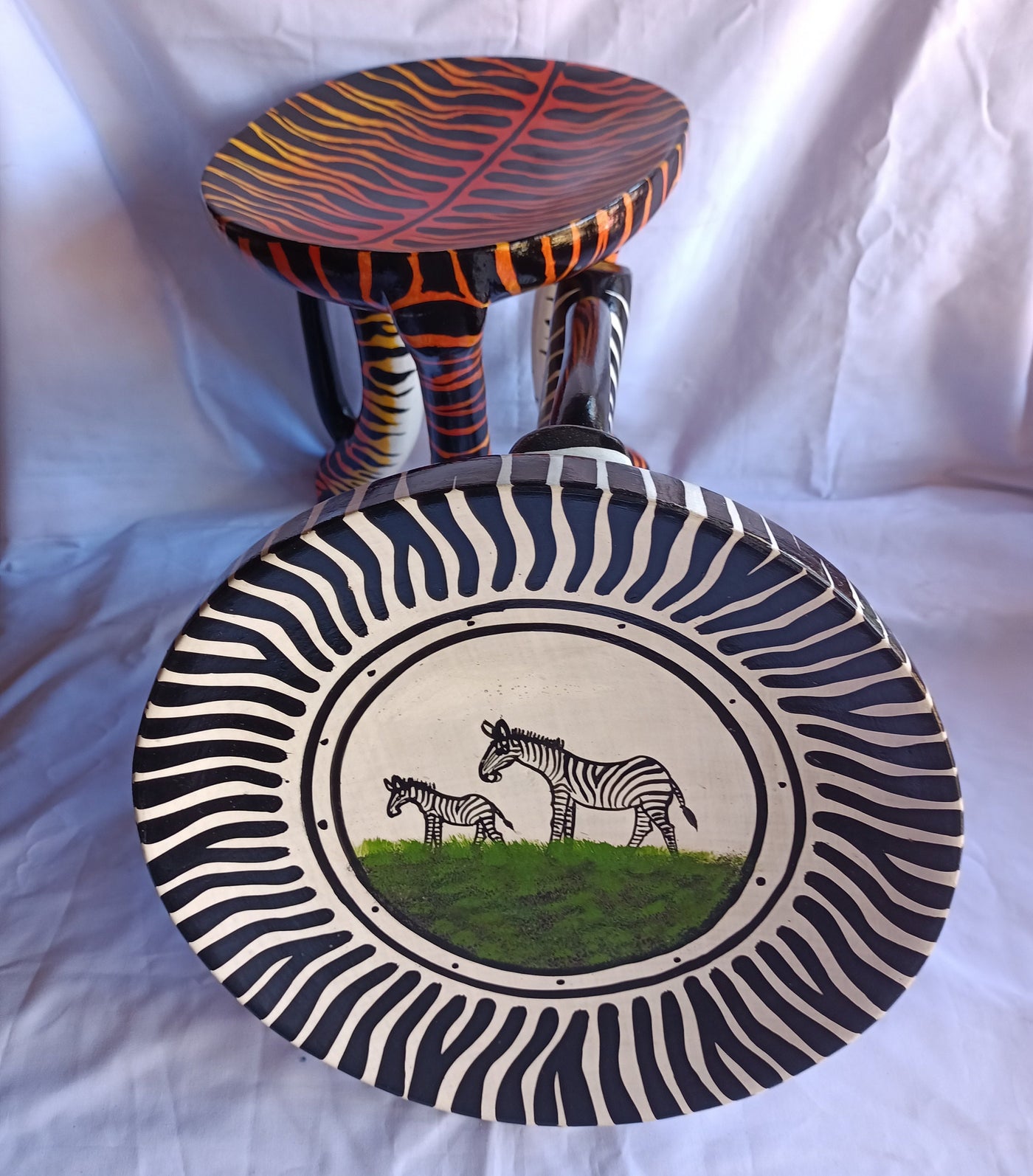 Two Gorgeous Hand carved Tiger and Zebra 3 legged Stools set of 2 with Handles. Modern maasai Wildlife Themed Stools. Bulk.The Senufo pair