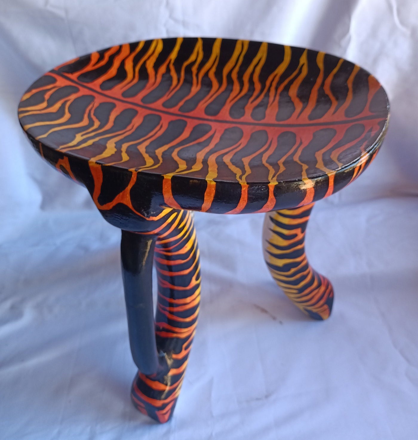 Beautiful Handmade Oval Wood enTiger Print 3 legged Stool with a handle. Modern Maasai Wildlife Themed Stool. Available in Bulk. Neo Senufo.