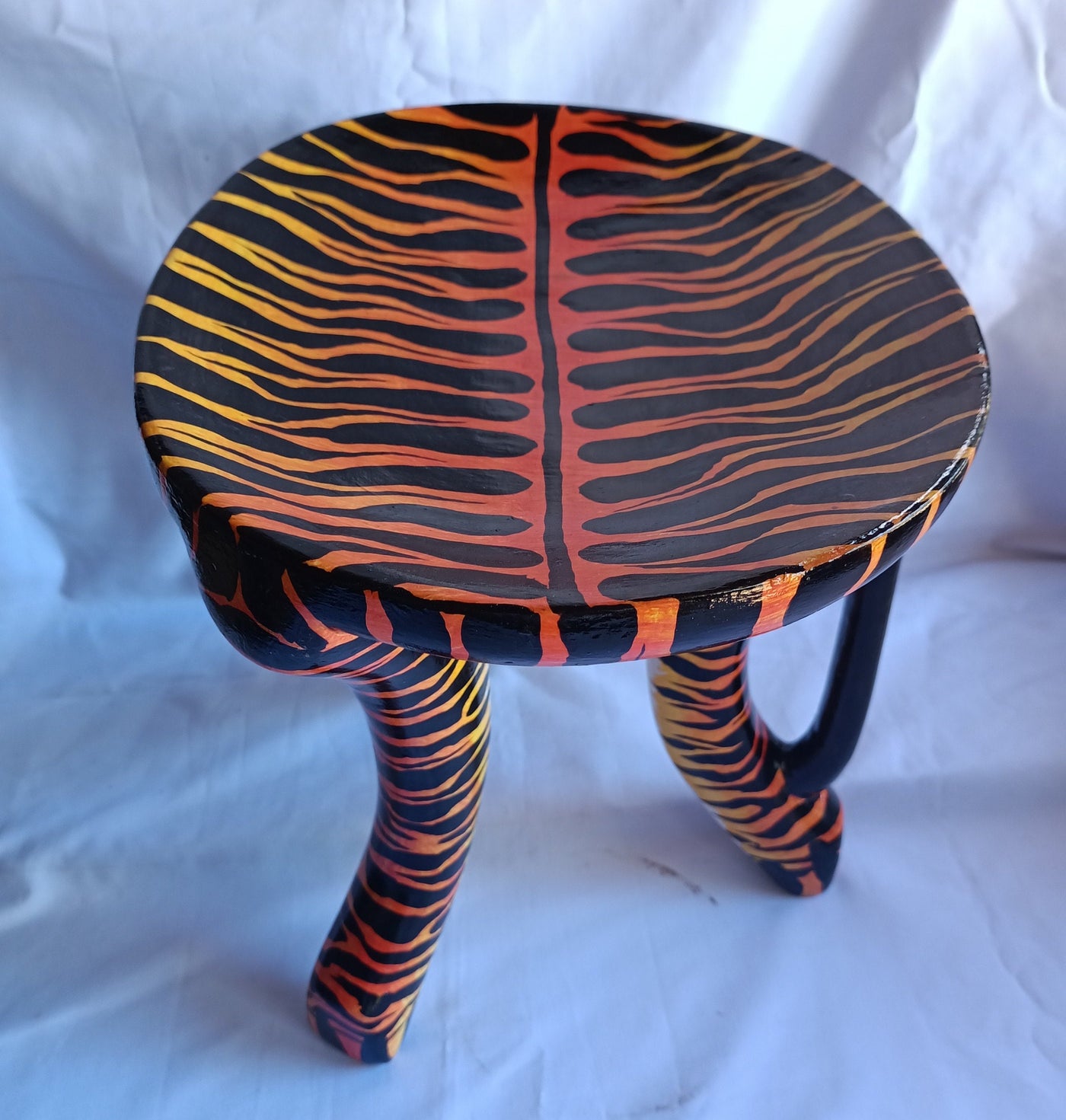Beautiful Handmade Oval Wood enTiger Print 3 legged Stool with a handle. Modern Maasai Wildlife Themed Stool. Available in Bulk. Neo Senufo.