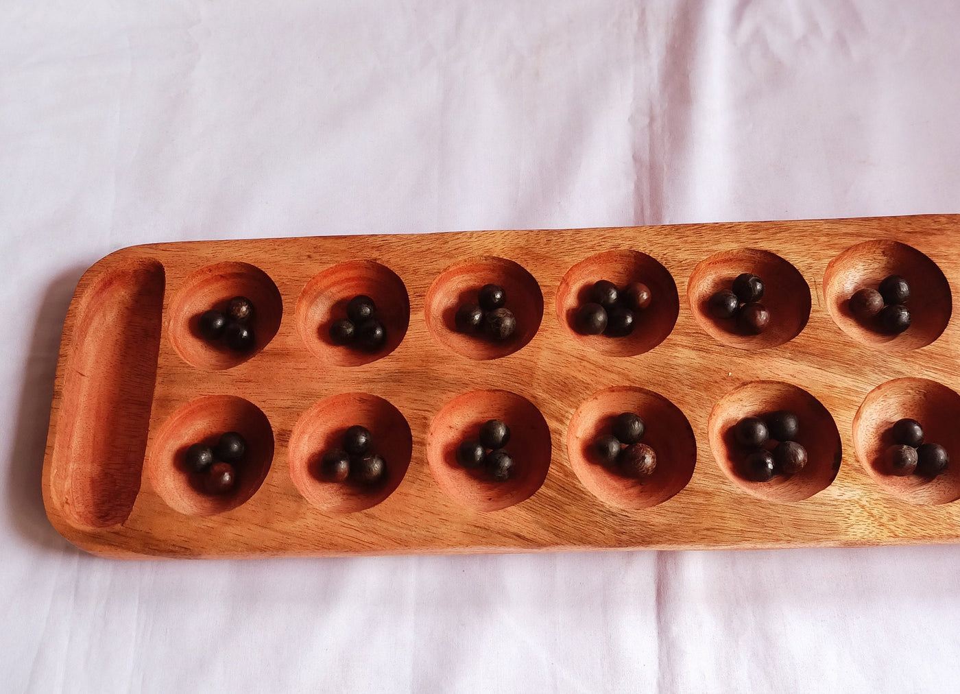 Wholesale . Large 24"×6" Mancalla Board Game With Natural Black Seeds.2 opponents Mankala 60 by 15 Cm with 16 Depressions and edge stores.
