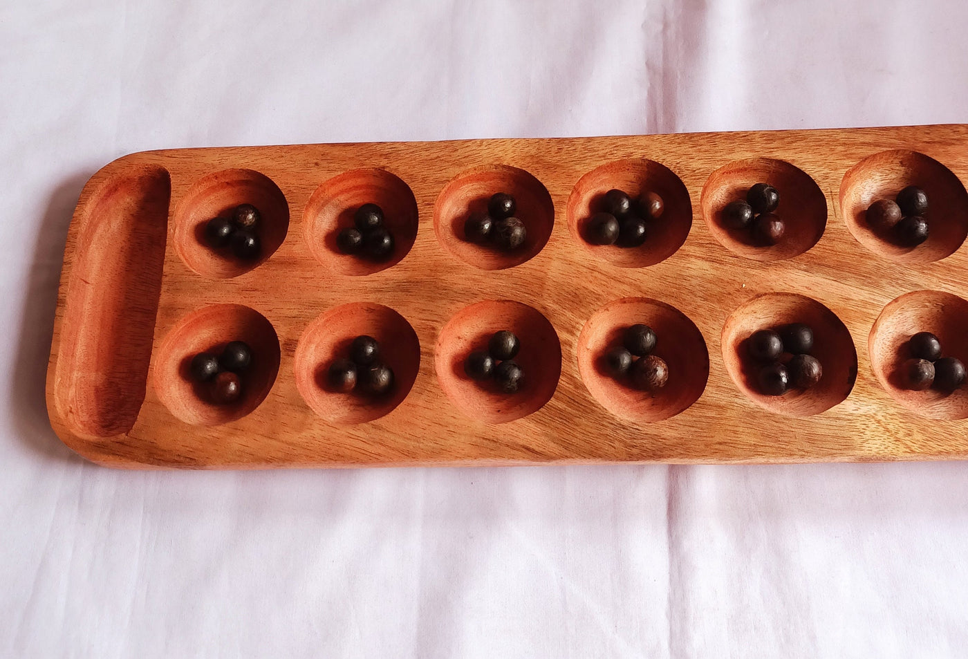 Wholesale . Large 24"×6" Mancalla Board Game With Natural Black Seeds.2 opponents Mankala 60 by 15 Cm with 16 Depressions and edge stores.