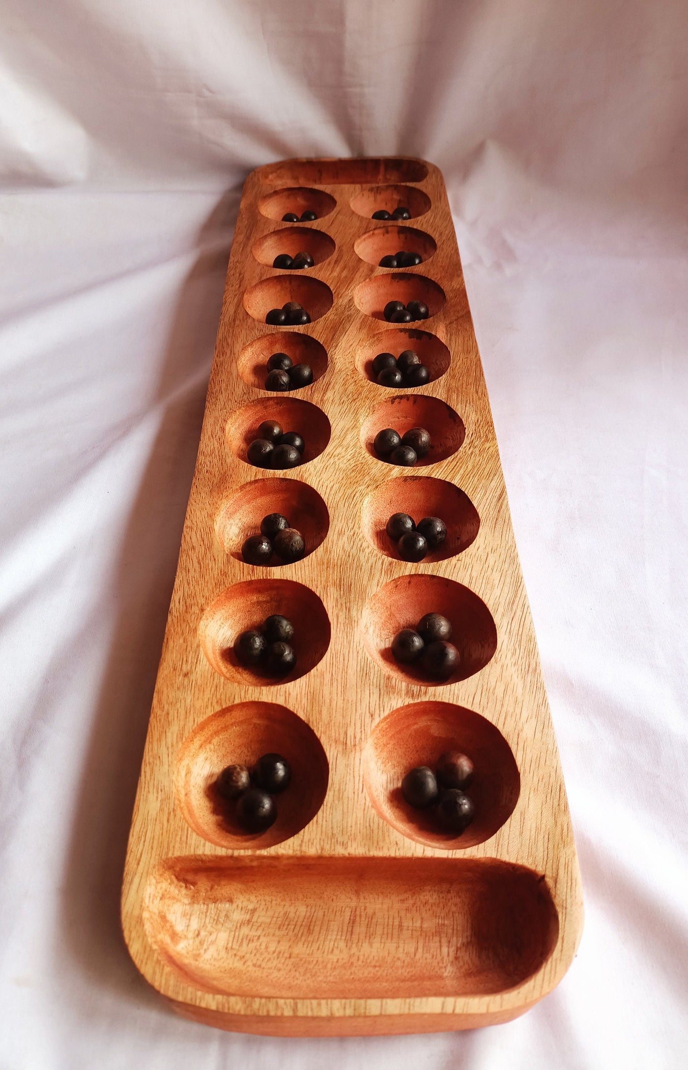 Wholesale . Large 24"×6" Mancalla Board Game With Natural Black Seeds.2 opponents Mankala 60 by 15 Cm with 16 Depressions and edge stores.