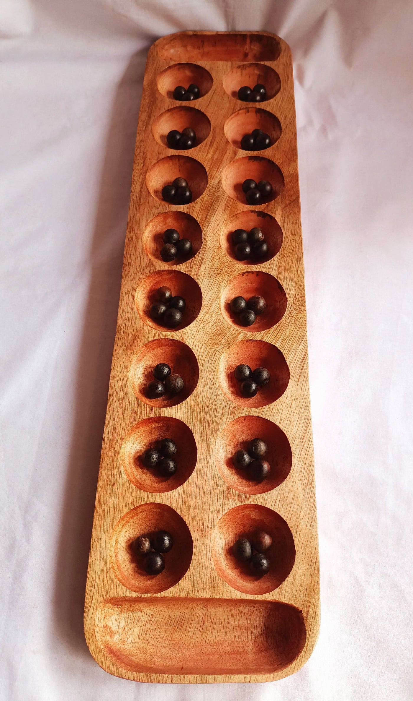 Wholesale . Large 24"×6" Mancalla Board Game With Natural Black Seeds.2 opponents Mankala 60 by 15 Cm with 16 Depressions and edge stores.