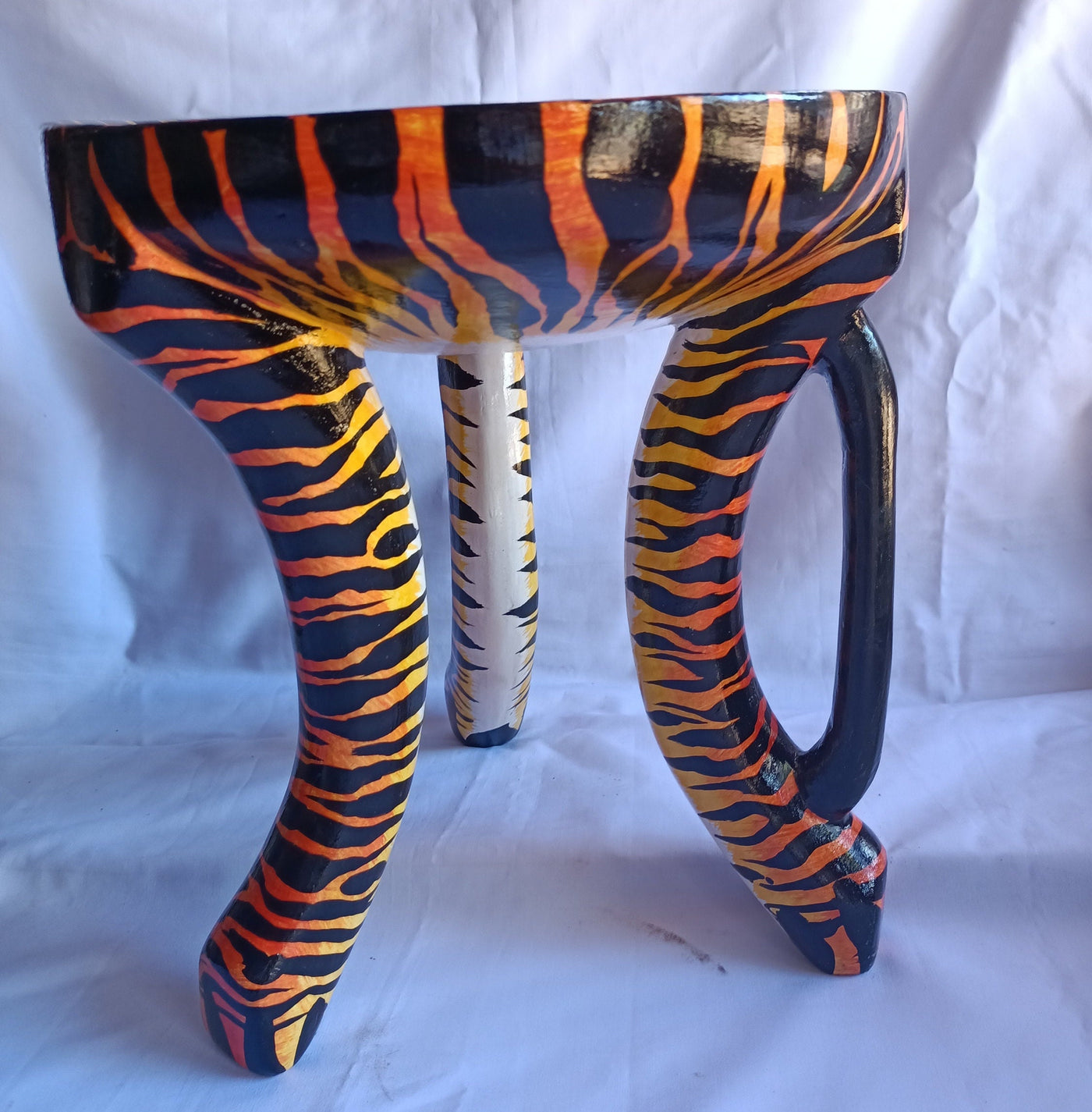 Beautiful Handmade Oval Wood enTiger Print 3 legged Stool with a handle. Modern Maasai Wildlife Themed Stool. Available in Bulk. Neo Senufo.