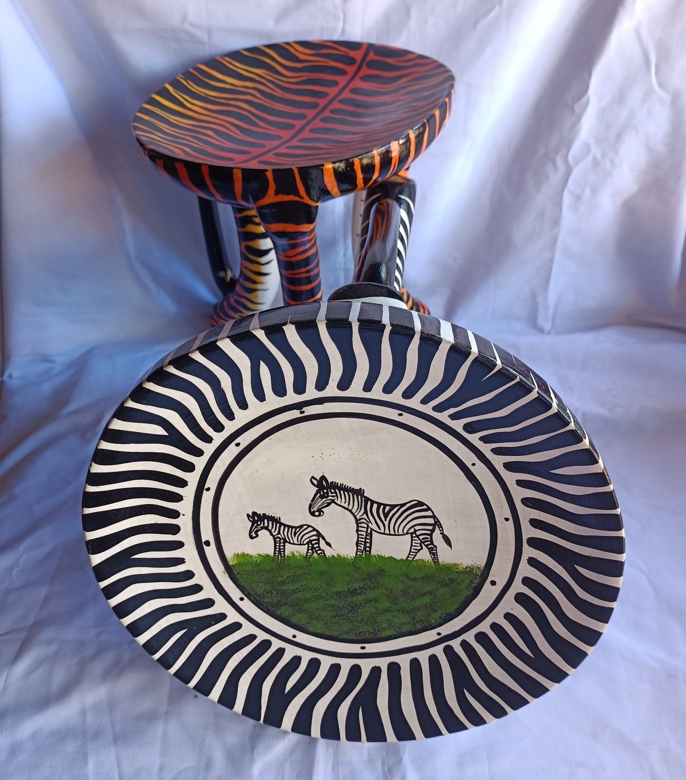 Two Gorgeous Hand carved Tiger and Zebra 3 legged Stools set of 2 with Handles. Modern maasai Wildlife Themed Stools. Bulk.The Senufo pair